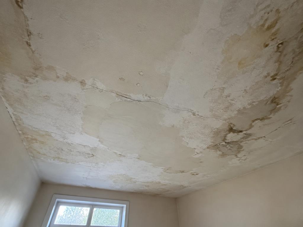 Before: Cracked, water-stained ceiling with patchy texture