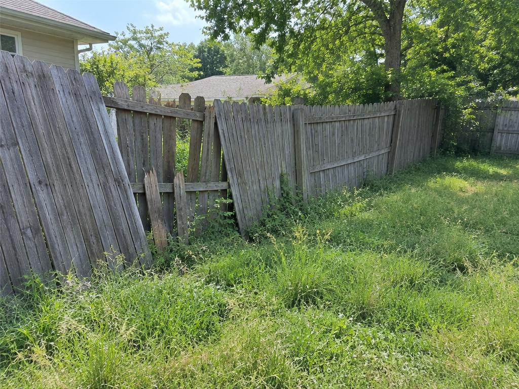 Before: Leaning fence with broken pickets
