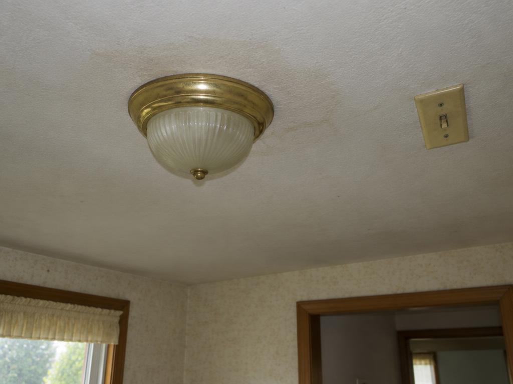 Before: Dated fixture on a dingy ceiling
